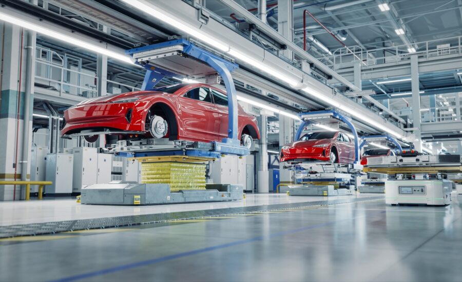 EV Production Line on Advanced Automated Smart Factory. High Performance Electric Car Manufacturing. Car Batteries being Attached to Electric Vehicles on Assembly line. AGV Transport Batteries.